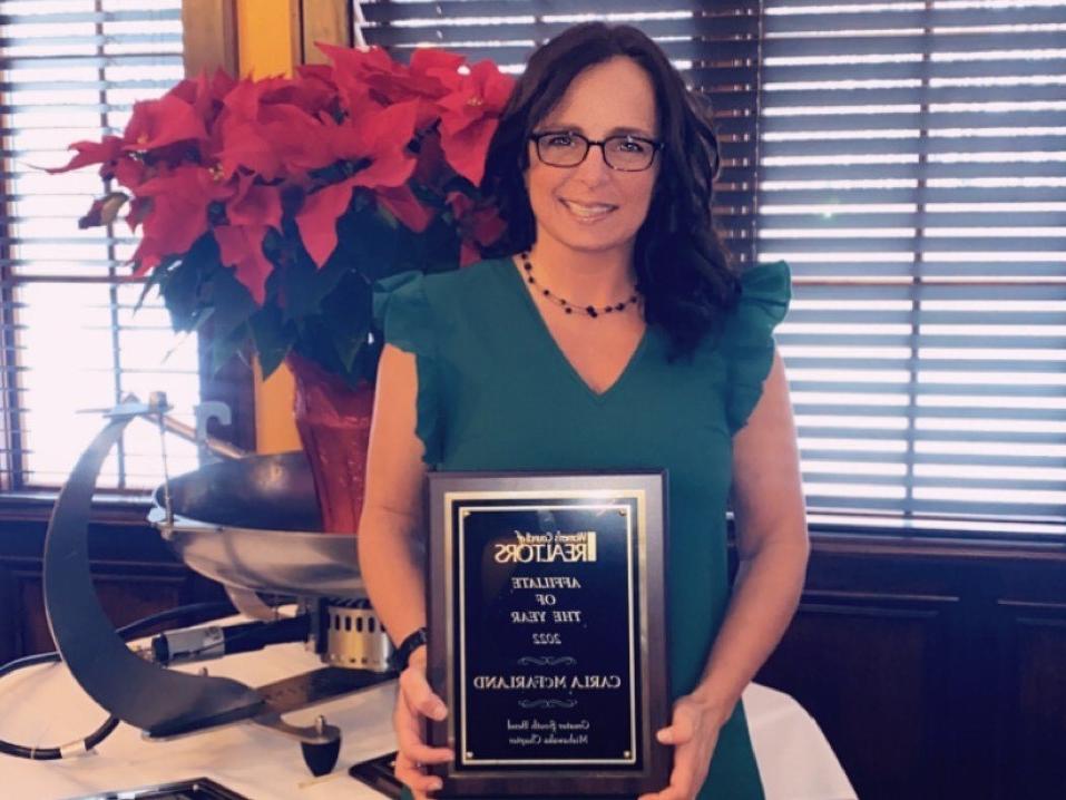Carla McFarland with her award from the Women’s Council of Realtors
