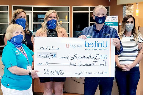 United Presents Check to Big Brothers Big Sisters